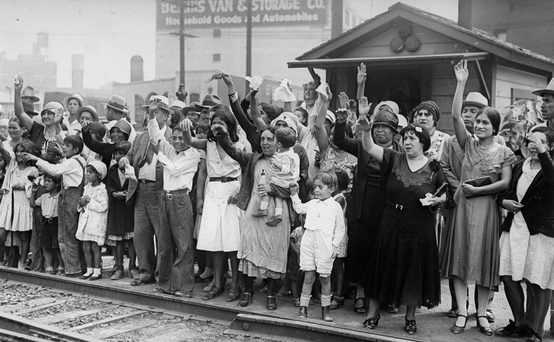 families waiving goodbye at a train station
